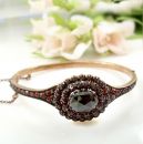 Vintage garnet bangle with an oval  facetted center stone